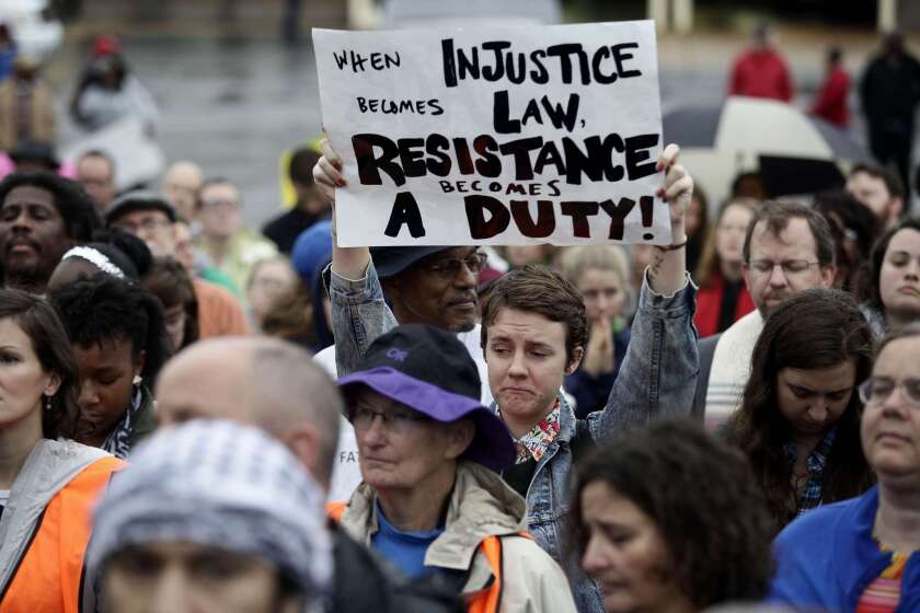 Demonstrators march to the Ferguson police station.