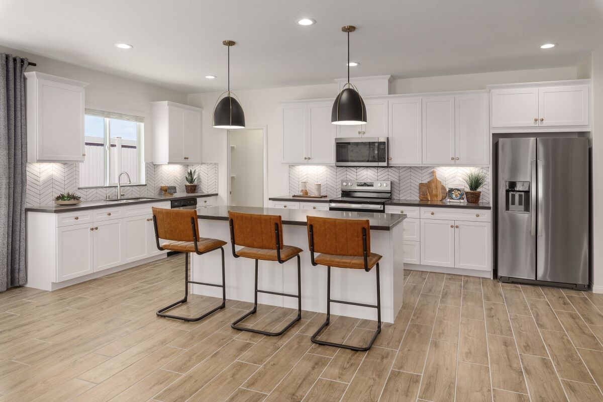 A kitchen with island and stools
