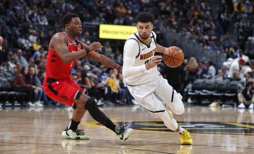 FILE - Denver Nuggets guard Jamal Murray, right, rives past Toronto Raptors guard Kyle Lowry in the second half of an NBA basketball game in Denver, in this Sunday, March 1, 2020, file photo. The Nuggets will open the NBA basketball exhibition season with two home contests against the Portland Trailblazers this week. (AP Photo/David Zalubowski, File)