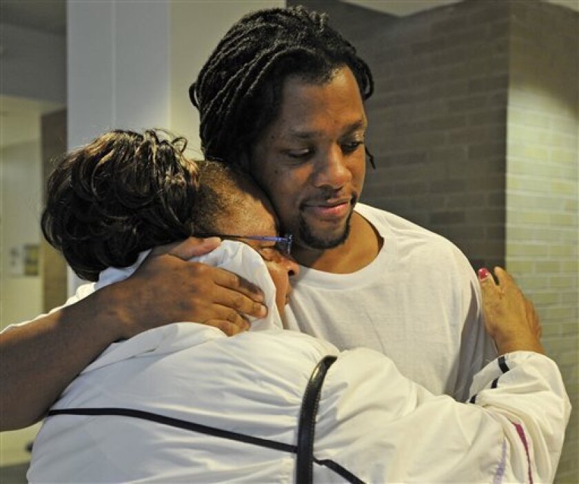 Kenneth Kagonyera hugs his grandmother Alice McLean after being proclaimed innocent and released from prison on Thursday, Sept. 22, 2011 in Asheville, N.C. Kagonyera walked out of jail Thursday afternoon, hours after being found innocent along with Robert Wilcoxson for a 2000 murder. Wilcoxson and Kagonyera had pleaded guilty to second-degree murder in the death of Walter Bowman. They said they agreed to the pleas to avoid the possibility of the death penalty or life behind bars. (AP Photo/The Asheville Citizen-Times, Erin Brethauer)