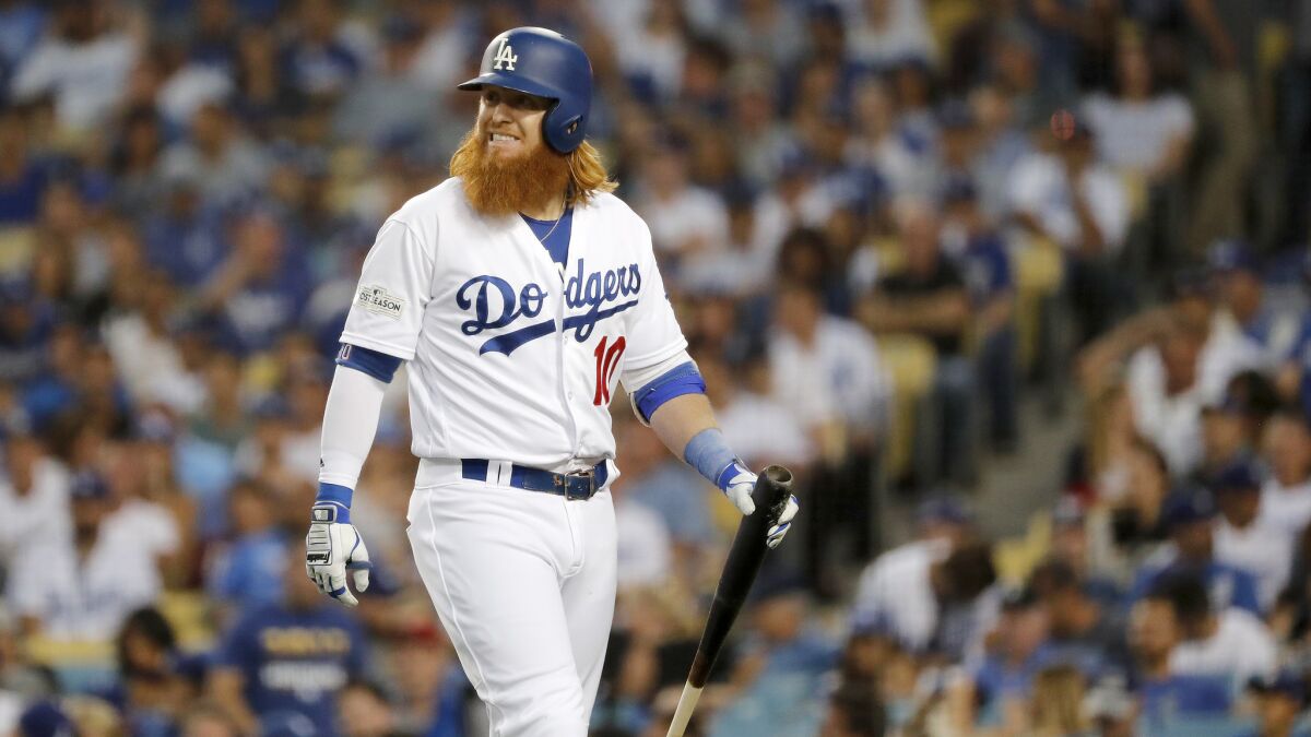 Dodgers Justin Turner grimaces after popping out with a runner on base.
