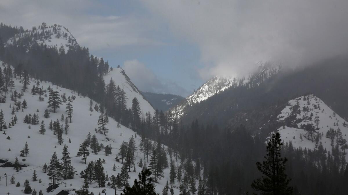 The sun breaks through clouds that brought snow to the Sierra Nevada on March 30.