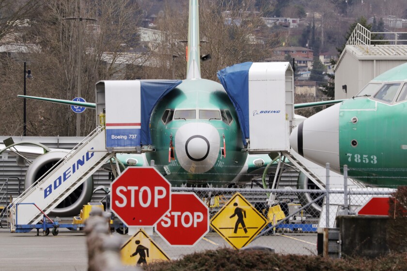 FILE - In this Monday, Dec. 16, 2019, file photo, Boeing 737 Max jets sit parked in Renton, Wash. American Airlines said Tuesday, Jan. 14, 2020, that it is removing the Boeing 737 Max from its schedule for two more months and canceling nearly 20,000 flights through early June, an acknowledgment of the ongoing uncertainty over when the grounded plane will fly again. (AP Photo/Elaine Thompson, File)