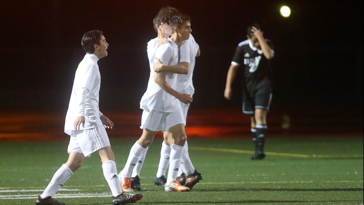 Niko Urban, middle, seen celebrating with his Corona del Mar High teammates at Estancia on Dec. 5, has helped the Sea Kings start the season 6-0.