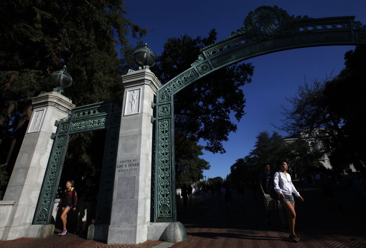 Students walk through the Sather Arch in the early-morning light on the UC Berkeley campus. Health officials at the school are investigating a possible outbreak of norovirus.
