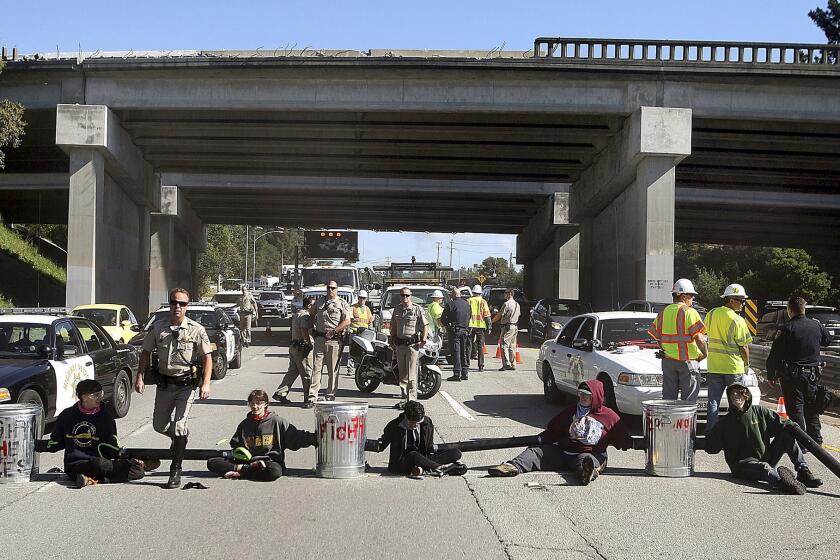 UC Santa Cruz students block traffic to protest tuition hikes on Tuesday.