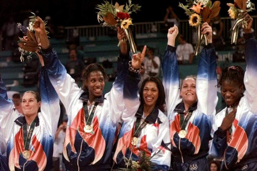 FILe - In this Aug. 4, 1996, file photo, U.S. women's basketball team members wear their gold medals during ceremonies at the Centennial Summer Olympic Games in Atlanta. From left are Jennifer Azzi, Lisa Leslie, Carla McGhee, Katy Steding and Sheryl Swoopes. That team, which started training together in 1995, was the foundation for the launch of the ABL and the WNBA. The ABL lasted only two years, but the WNBA is now in its 20th season. (AP Photo/Susan Ragan, File)