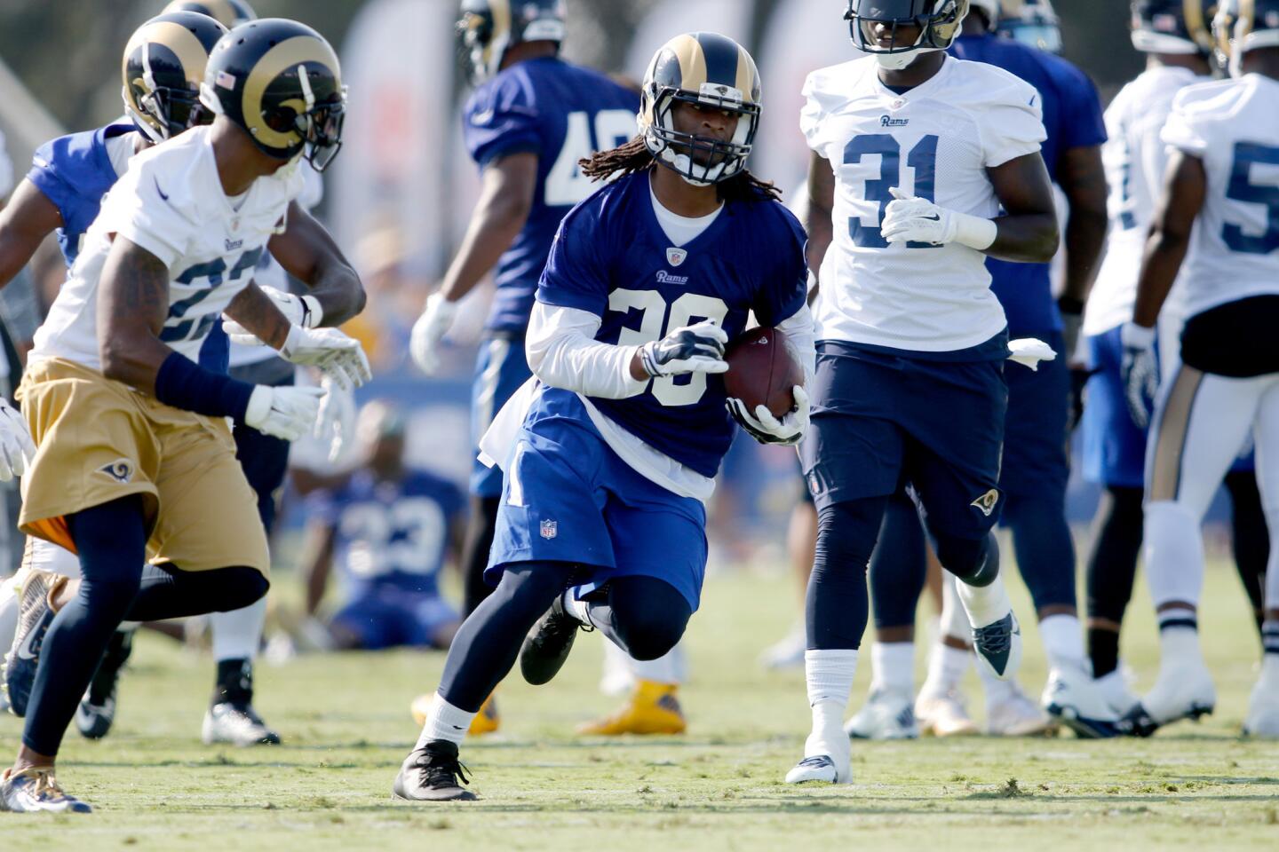 Running back Todd Gurley (30) carries the ball upfield during the Rams' first workout on Saturday at UC Irvine.