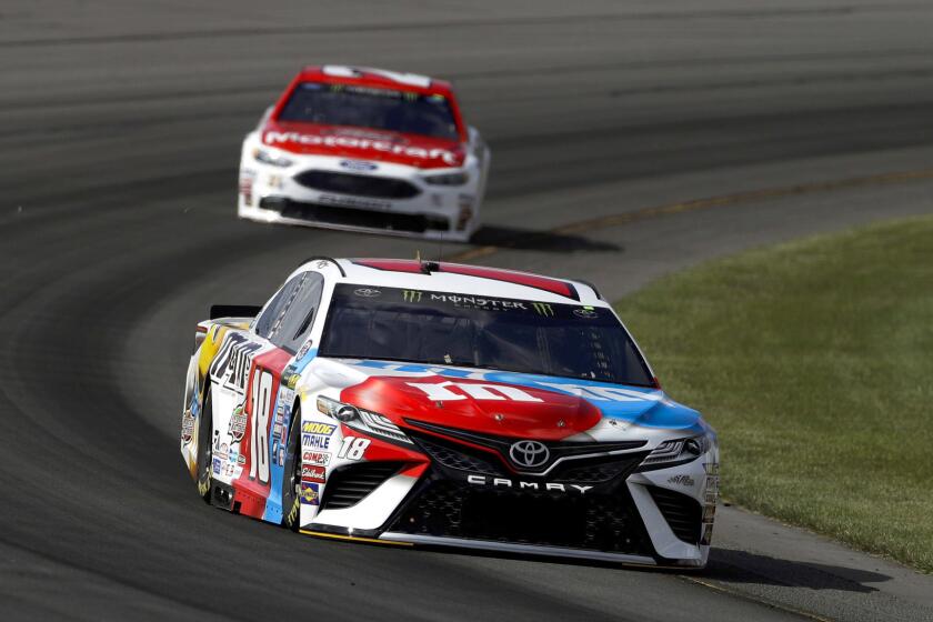 Kyle Busch, bottom, leads Ryan Blaney through Turn 3 during qualifying for Sunday's NASCAR Cup Series Pocono 400 auto race, Friday, June 9, 2017, in Long Pond, Pa. Busch won the pole. (AP Photo/Matt Slocum)