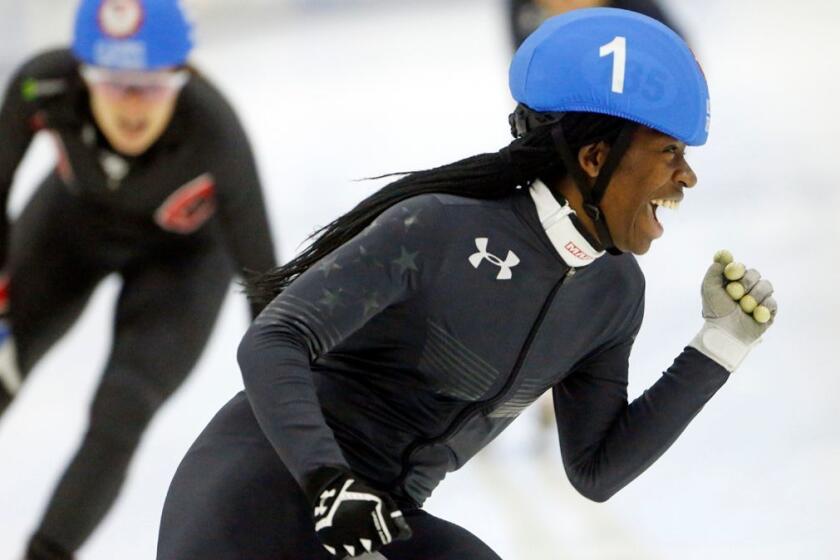 FILE - In this Dec. 16, 2017, file photo, Maame Biney (1) celebrates after winning the women's 500-meter final A during the U.S. Olympic short track speedskating trials in Kearns, Utah. Biney is the first black female skater to make a U.S. short track Olympic team. The 17-year-old was born in Ghana and moved to Virginia with her father as a 6-year-old. She started skating soon after. Her explosive speed off the starting line and giggly personality could make her a star at the games even if she doesnât medal. (AP Photo/Rick Bowmer, File)