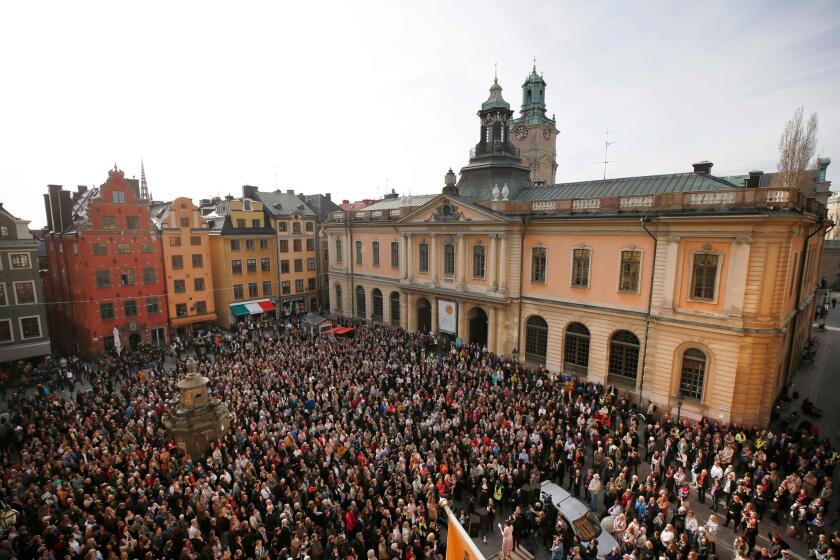 People gather at Stortorget square in Stockholm while the Swedish Academy held its weekly meeting at the Old Stock Exchange building seen in the background on April 19, 2018. The participants gatheres to show their support for former Academy member and Permanent Secretary Sara Danius who stepped down last Thursday by wearing her hallmark, a tied blouse. / AFP PHOTO / TT NEWS AGENCY AND TT News Agency / Fredrik Persson / Sweden OUTFREDRIK PERSSON/AFP/Getty Images ** OUTS - ELSENT, FPG, CM - OUTS * NM, PH, VA if sourced by CT, LA or MoD **