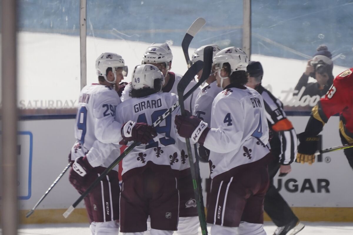 The Colorado Avalanche's Samuel Girard (49) celebrates with his teammates after scoring in the first period Feb. 20, 2021.