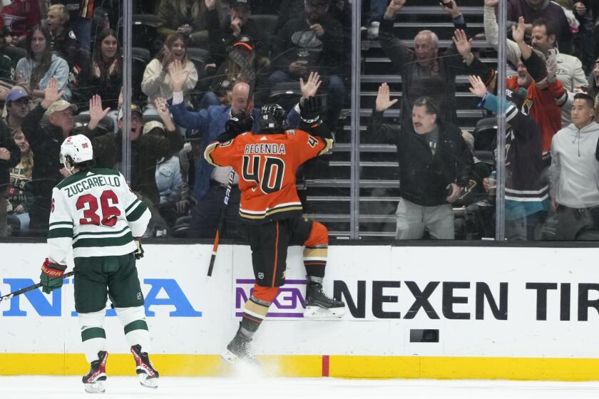 Anaheim Ducks' Pavol Regenda with fans after his goal against the Minnesota Wild during the second period of an NHL hockey game Wednesday, Nov. 9, 2022, in Anaheim, Calif. (AP Photo/Jae C. Hong)