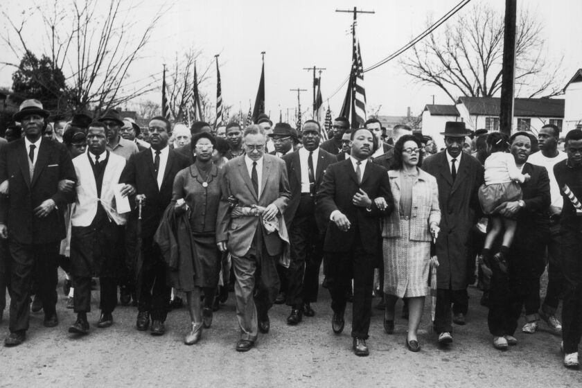 March 1965: American civil rights campaigner Martin Luther King (1929 - 1968) and his wife Coretta Scott King lead a black voting rights march from Selma, Alabama, to the state capital in Montgomery; among those pictured are, front row, politician and civil rights activist John Lewis (1940 - 2020), Reverend Ralph Abernathy (1926 - 1990), Ruth Harris Bunche (1906 - 1988), Nobel Prize-winning political scientist and diplomat Ralph Bunche (1904 - 1971), activist Hosea Williams (1926 - 2000). (Photo by William Lovelace/Express/Getty Images)