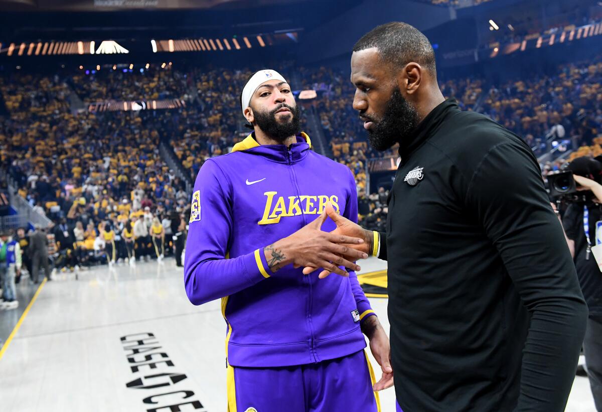 Lakers stars Anthony Davis, left, and LeBron James shake hands before Game 1.