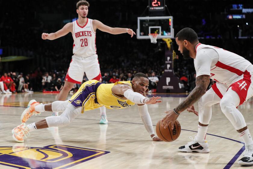 Los Angeles, CA, Tuesday, November 2, 2021 -Los Angeles Lakers guard Russell Westbrook (0) dives after a loose ball that is collected by Houston Rockets guard D.J. Augustin (14) at Staples Center. (Robert Gauthier/Los Angeles Times)