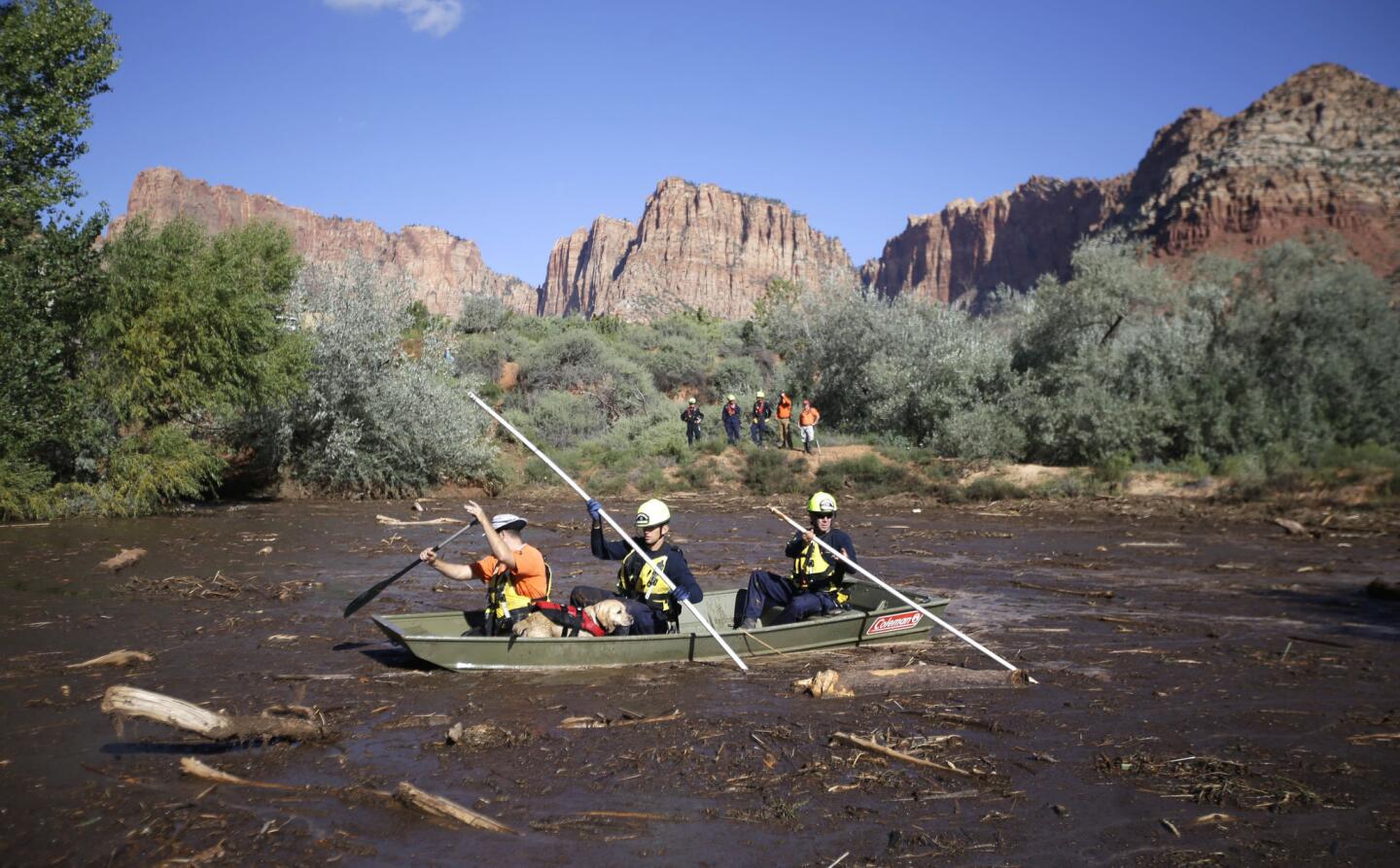 Searchers comb through mud and debris during a search for the remaining victims of a flash flood in Hildale, Utah. The flood water swept away multiple vehicles in the Utah-Arizona border town, killing several people.