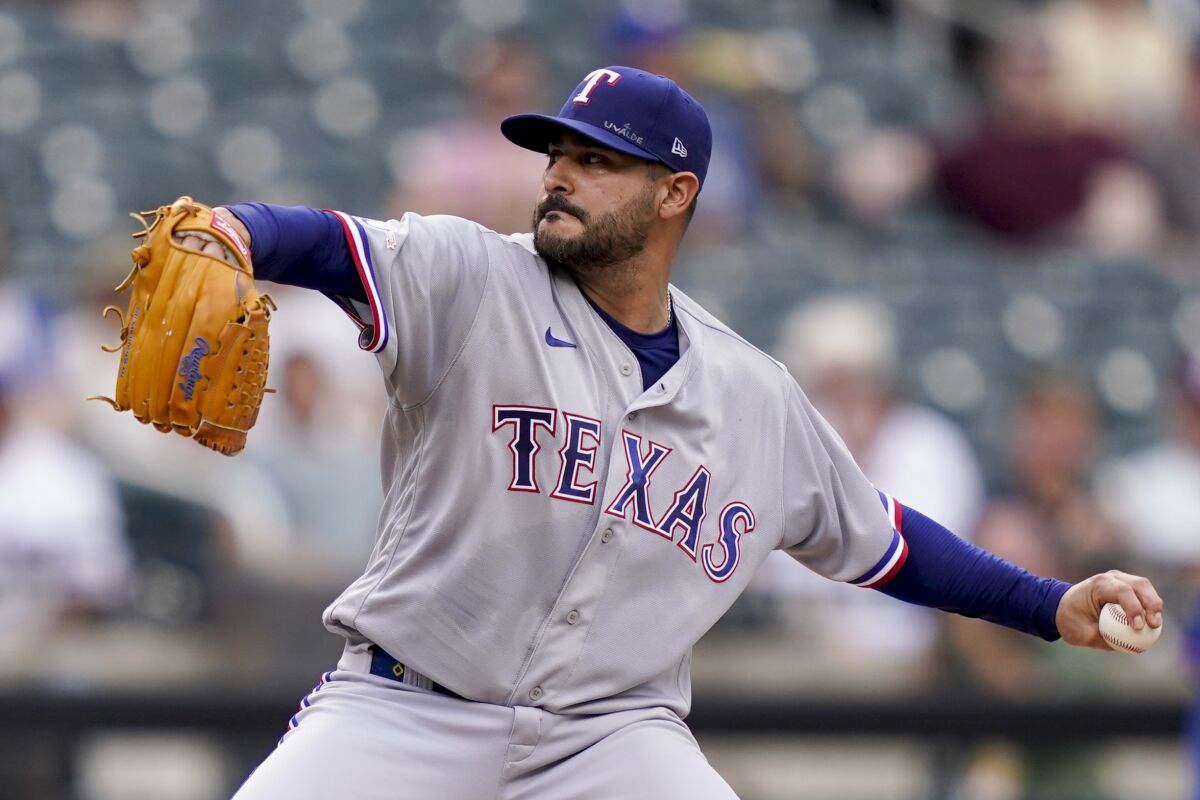 Texas Rangers starting pitcher Martin Perez (54) throws in the first inning of a baseball game against the New York Mets, Saturday, July 2, 2022, in New York. (AP Photo/John Minchillo)