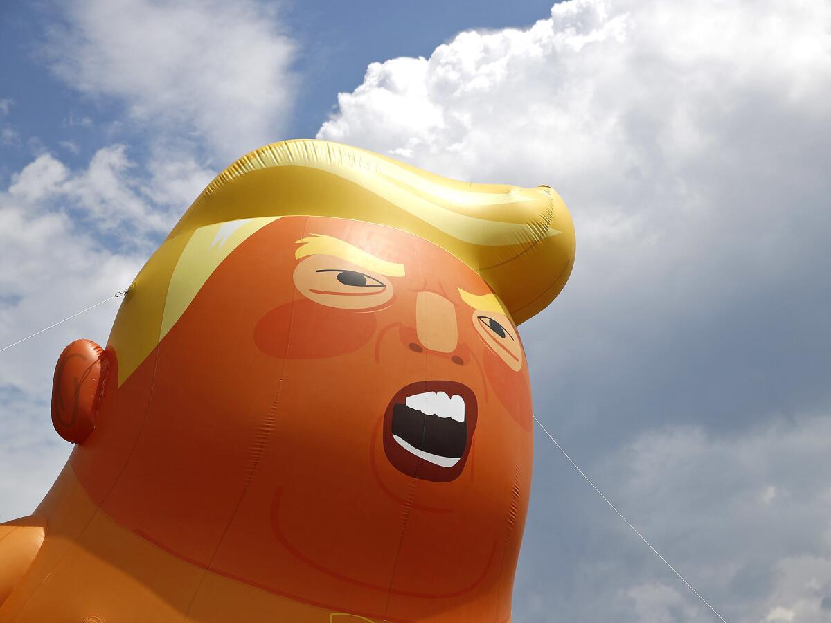 The "Baby Trump" balloon flies again as the president visits California.