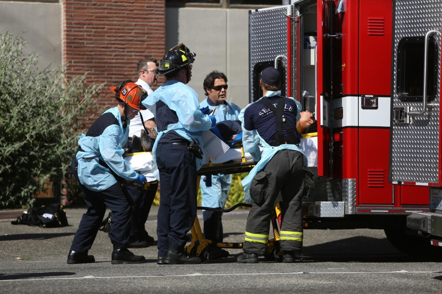Firefighters remove a victim from the scene of a shooting at Seattle Pacific University on June 5.