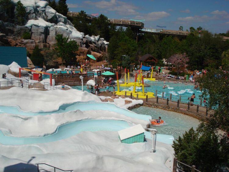 Guests can ride in orange tubes on curving slides through the Ski Patrol Training Camp at Disney's Blizzard Beach.