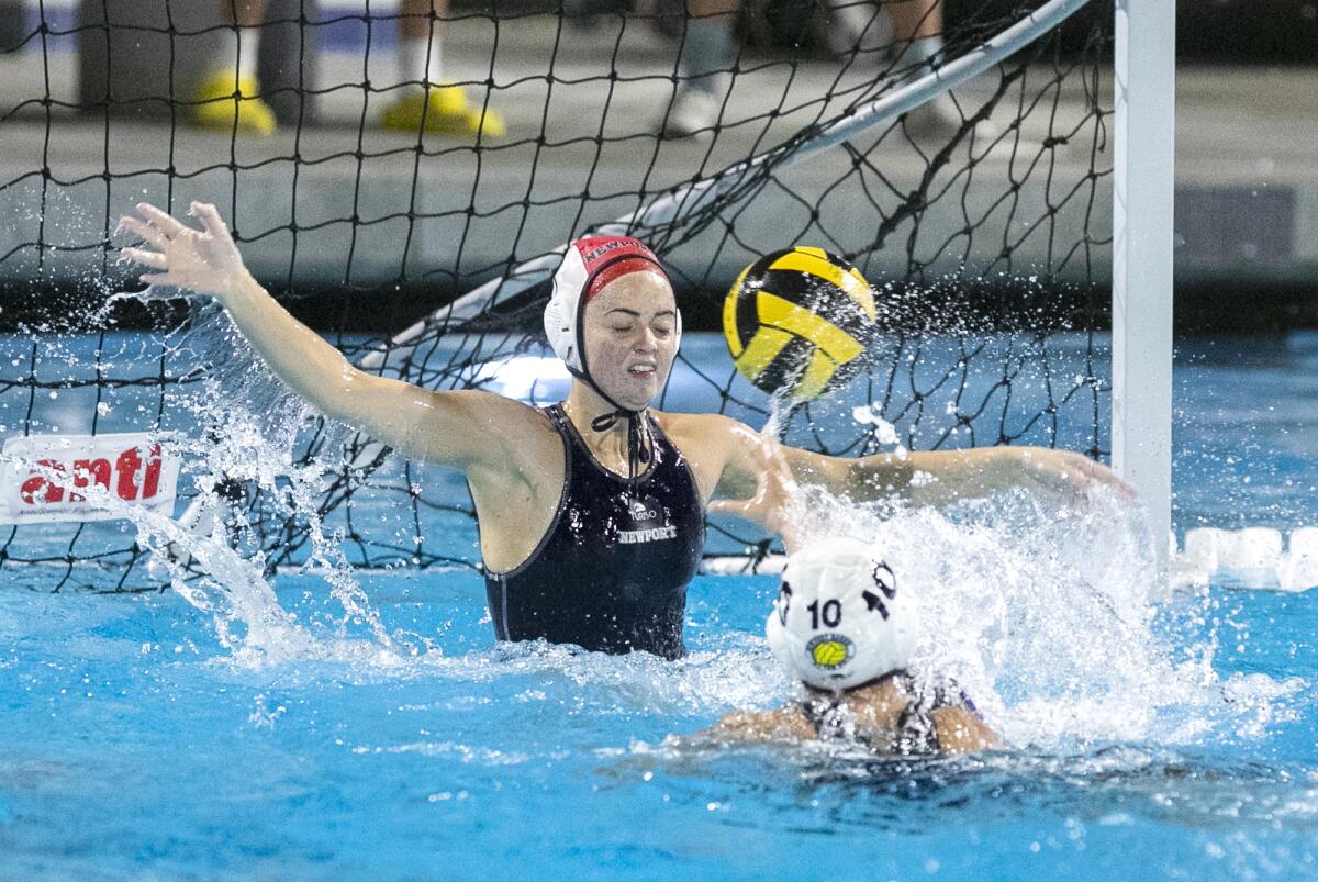 Newport Harbor's Anna Reed blocks a shot from Los Alamitos' Ashley Greger during Thursday's match.