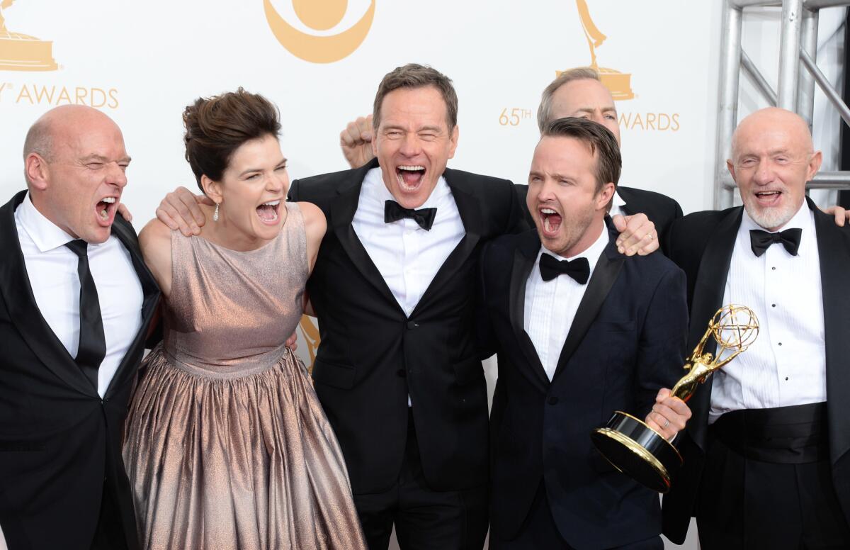 (L-R) Actors Dean Norris, Betsy Brandt, Bryan Cranston, Aaron Paul and Jonathan Banks, winners of Outstanding Drama Series for "Breaking Bad," pose in the press room during the 65th Annual Primetime Emmy Awards.