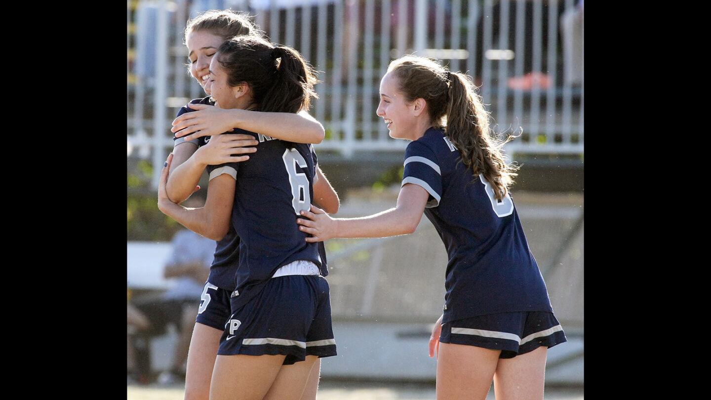 Flintridge Prep's Julia Gonzalez is congratulated by Hannah Barakat and Helen Schaefer after she scored the first point against Pasadena Poly during a match on Thursday, Feb. 11, 2016.