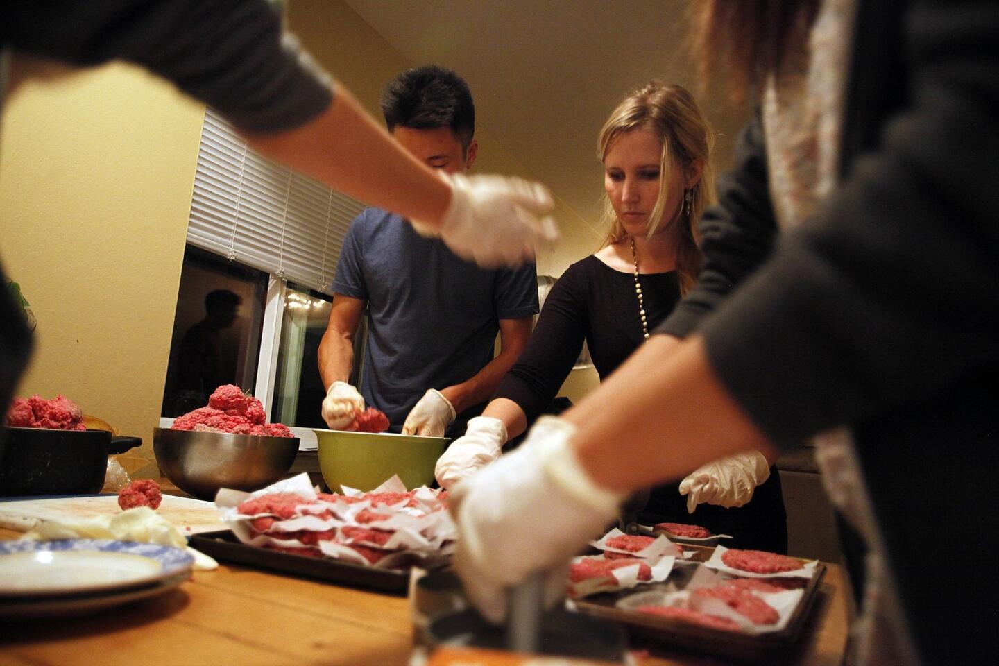 Students from UC Santa Barbara in Isla Vista make hamburgers in a leased building known as the Jesus Burgers house. After service, the grill is fired up.