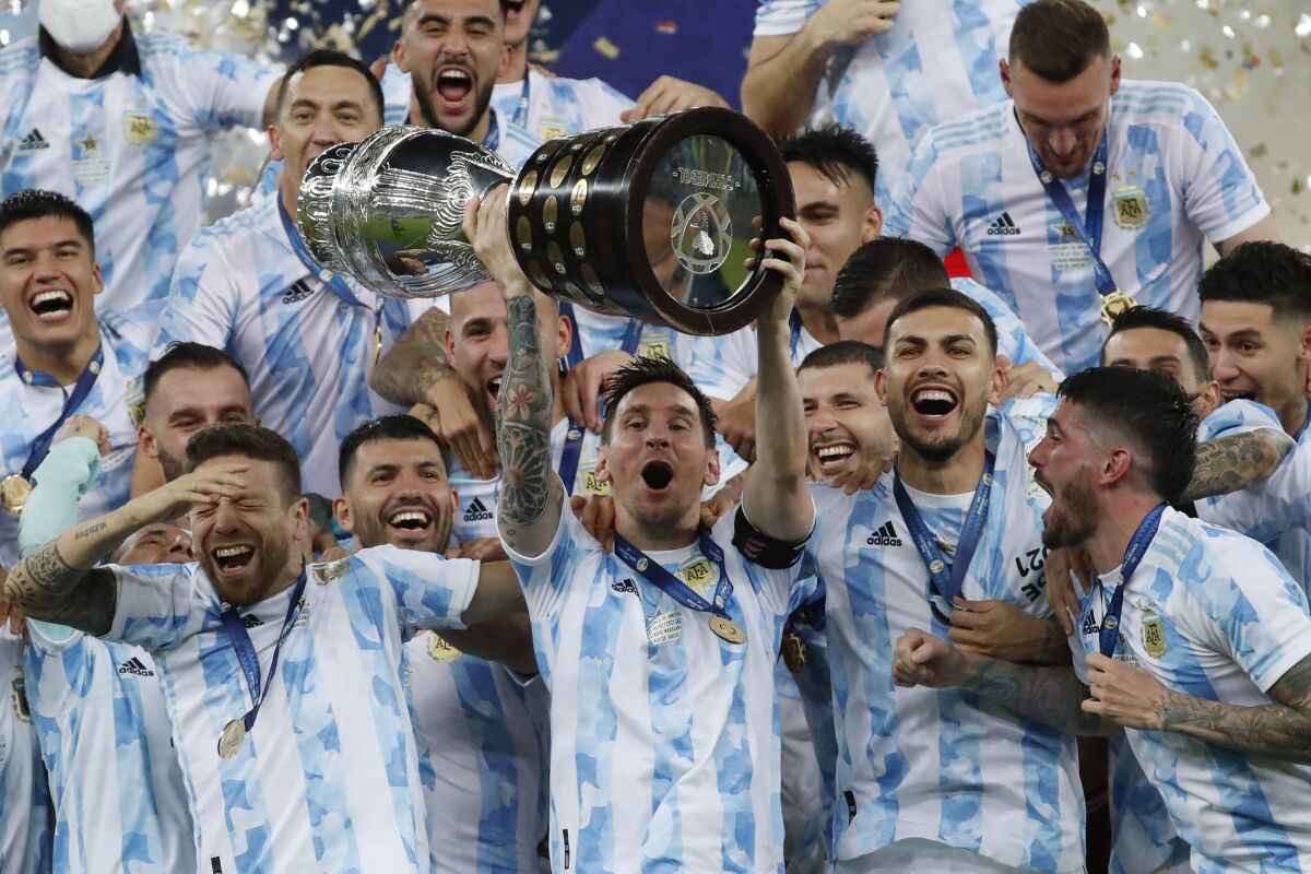 Argentina's Lionel Messi hoists the trophy after beating Brazil 1-0 in the Copa America final soccer match at Maracana stadium in Rio de Janeiro, Brazil, Saturday, July 10, 2021. (AP Photo/Bruna Prado)
