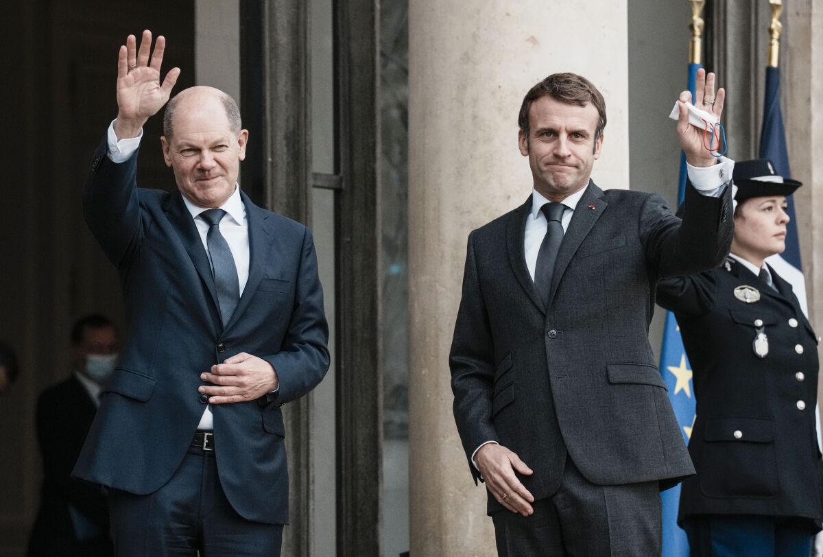 German Chancellor Olaf Scholz, left, is welcomed by French President Emmanuel Macron at the Elysee Palace in Paris, Friday, Dec. 10, 2021. Two days after taking office, Scholz visits the French President in Paris as well as top EU and Nato personnel in Brussels. (AP Photo/Thibault Camus)