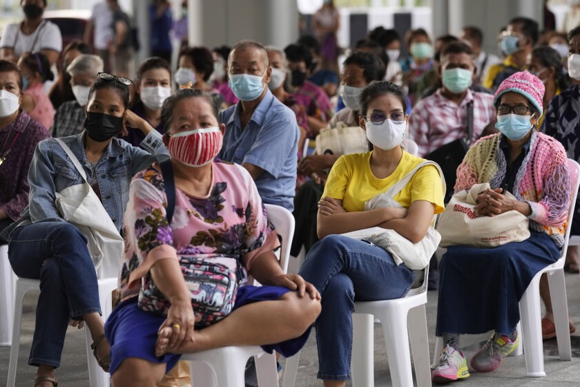Residents wait to receives shots of the AstraZeneca COVID-19 vaccine at the Central Vaccination Center in Bangkok, Thailand, Thursday, July 15, 2021. As many Asian countries battle against a new surge of coronavirus infections, for many their first, the slow-flow of vaccine doses from around the world is finally picking up speed, giving hope that low inoculation rates can increase rapidly and help blunt the effect of the rapidly-spreading delta variant. (AP Photo/Sakchai Lalit)