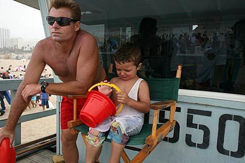 Dr. Paul Silka and a boy named Greg wait for the boy's parents to come looking for him on the beach north of the Santa Monica Pier.