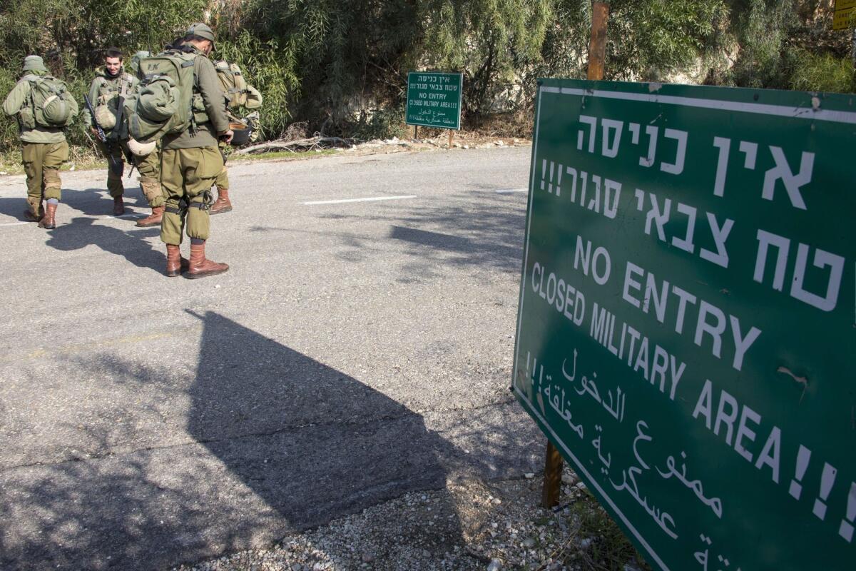 Israeli soldiers control access to one of the roads near the Israeli-Lebanese border Monday.