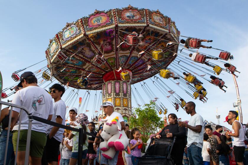 COSTA MESA, CA - JULY 25: People enjoy a Sunday at the Orange County Fair on Sunday, July 25, 2021 in Costa Mesa, CA.(Jason Armond / Los Angeles Times)