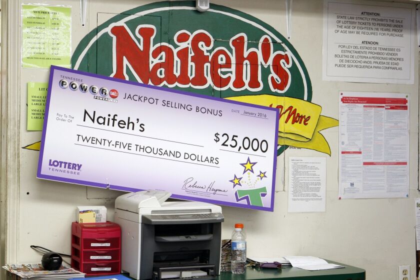 The check for the merchant's share of the winnings sits in Naifeh's Grocery in Munford, Tenn., Thursday, Jan. 14, 2016. One of the winning Powerball tickets in Wednesday's record jackpot drawing of $1.6 billion was sold at the store. (AP Photo/Karen Pulfer Focht)