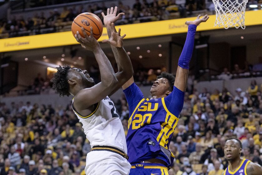 Missouri's Kobe Brown, left, shoots over LSU's Derek Fountain, right, during the second half of an NCAA college basketball game Wednesday, Feb. 1, 2023, in Columbia, Mo. Missouri won 87-77.(AP Photo/L.G. Patterson)