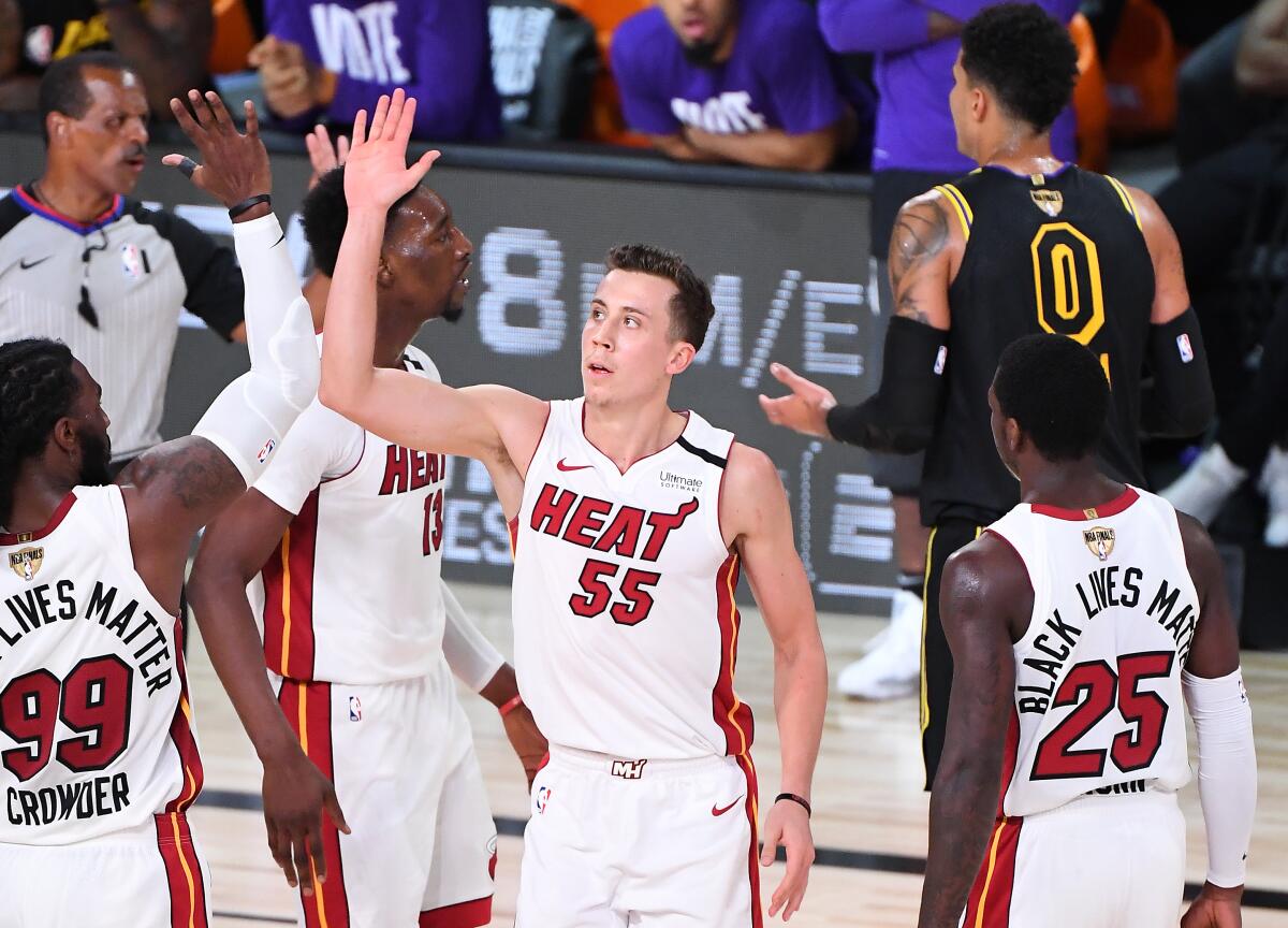 Heat forward Duncan Robinson celebrates with teammate Jae Crowder after making three-pointer and drawing a foul in Game 5.