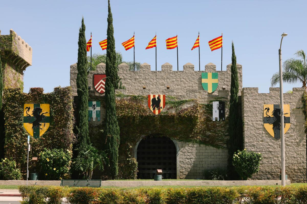 Flags fly atop a castle-like structure. 