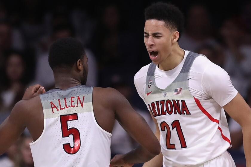 Arizona's Chance Comanche, right, celebrates with teammate Kadeem Allen after scoring against New Mexico during the second half Tuesday.