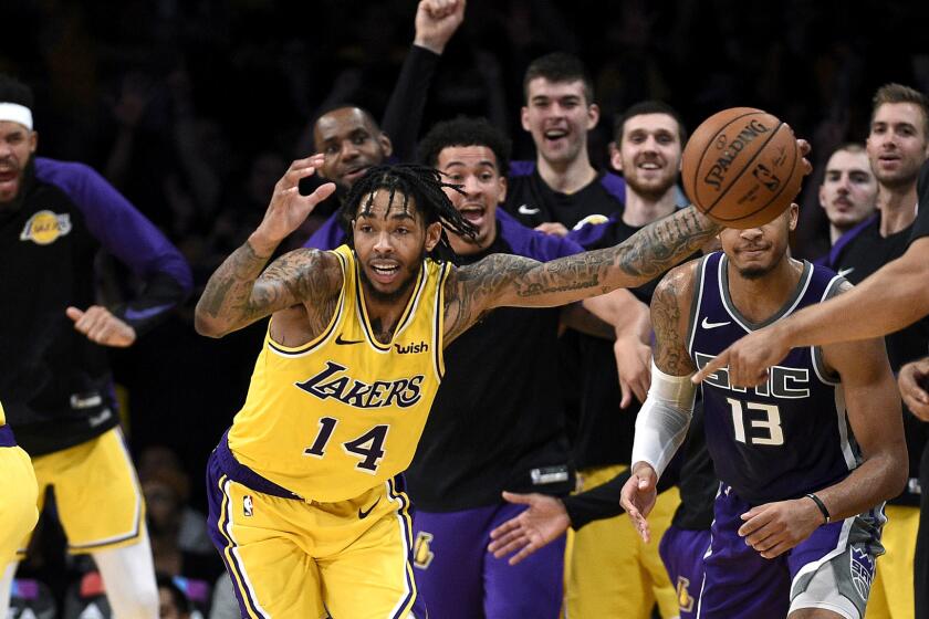 LOS ANGELES, CA - OCTOBER 04: Brandon Ingram #14 steels the inbound ball from Cameron Reynolds #13 of the Sacramento Kings as rest of his teammates cheer on at end of the game at Staples Center on October 4, 2018 in Los Angeles, California. NOTE TO USER: User expressly acknowledges and agrees that, by downloading and or using this photograph, User is consenting to the terms and conditions of the Getty Images License Agreement. (Photo by Kevork Djansezian/Getty Images) ** OUTS - ELSENT, FPG, CM - OUTS * NM, PH, VA if sourced by CT, LA or MoD **