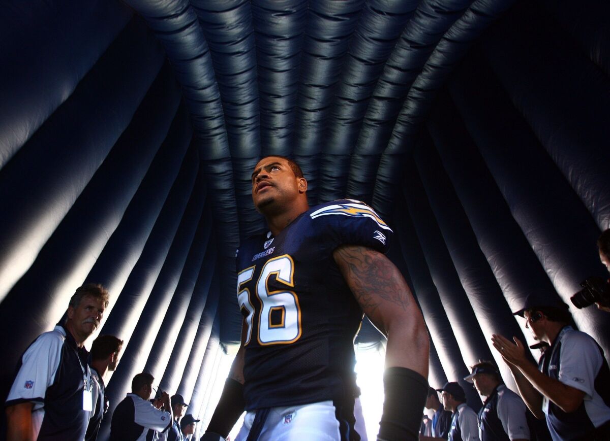 Shawne Merriman prepares to step onto the field before a San Diego Chargers-Seattle Seahawks game in San Diego.