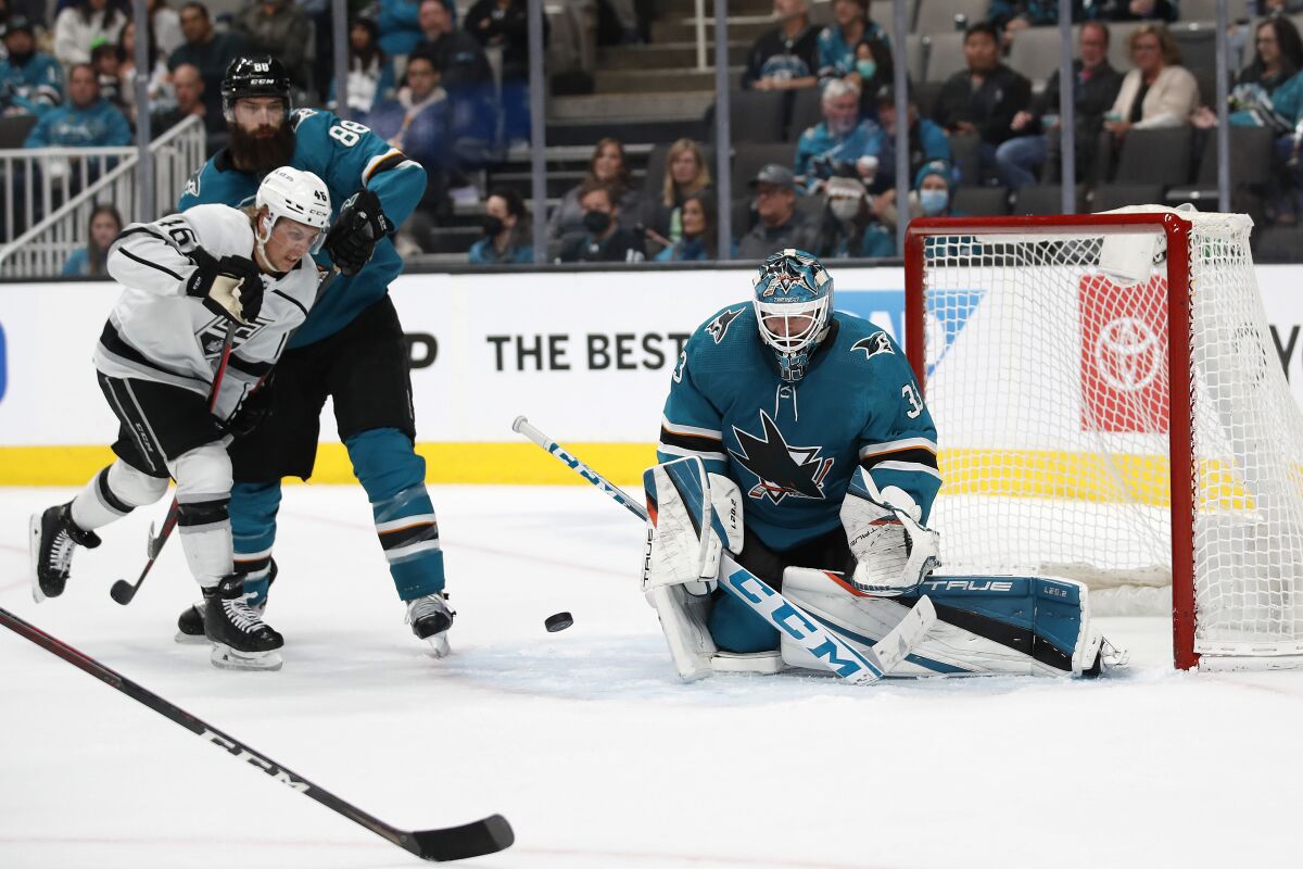 San Jose goalie Adin Hill makes one of his 29 saves as the Kings' Blake Lizotte (46) battles the Sharks' Brent Burns.