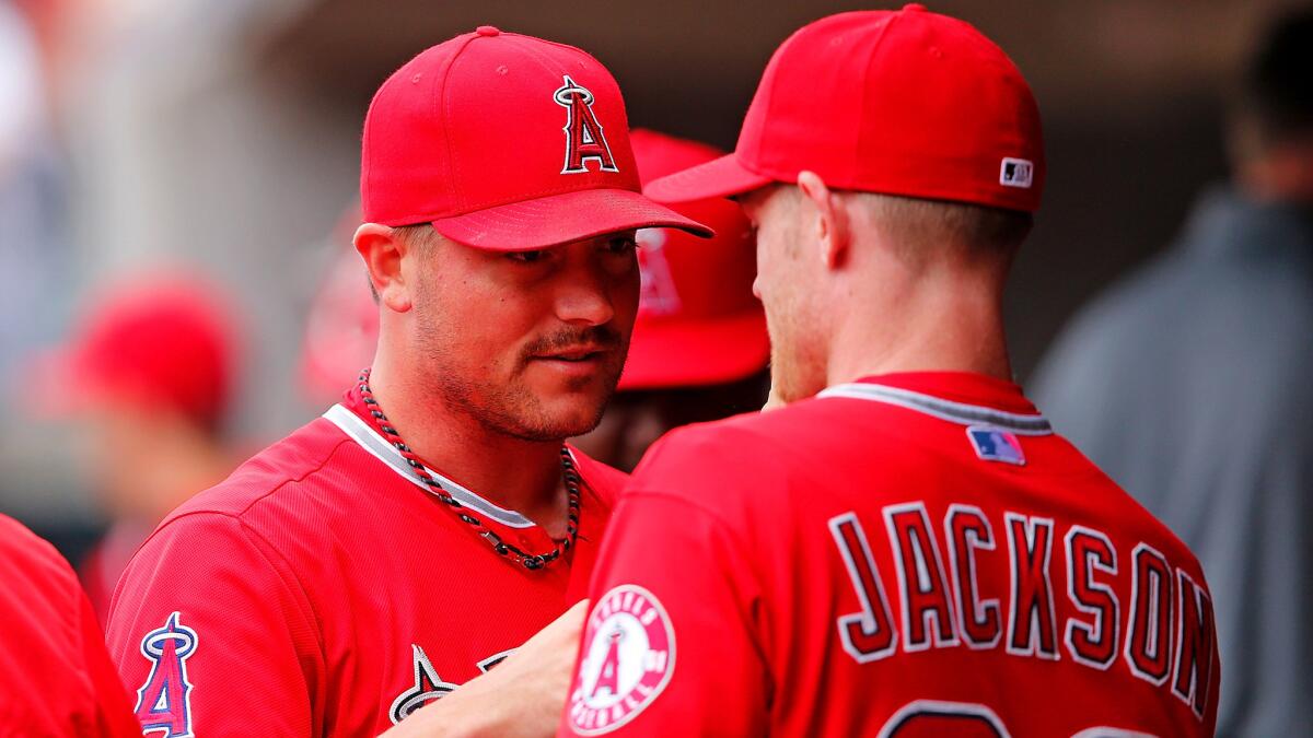 Angels reliever Joe Smith is congratulated by teammate Ryan Jackson after getting out of a jam against the Tigers in the eighth inning Thursday afternoon in Detroit.