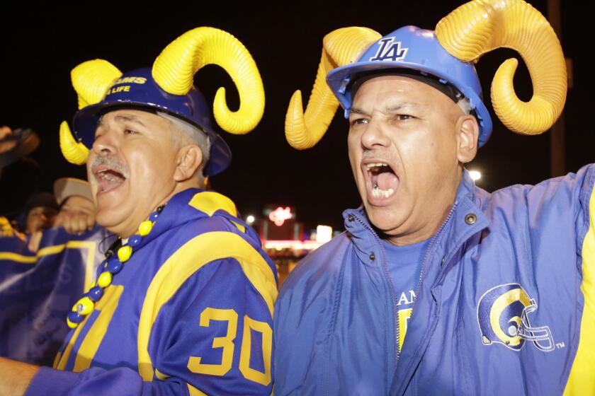 Football fans cheer for the return of the Rams to Los Angeles on the site of the old Hollywood Park horse-racing track in Inglewood on Tuesday, Jan. 12, 2016. Should switching venues be an opportunity to switch up the uniforms? Some fans say: "Don't mess with the horns."
