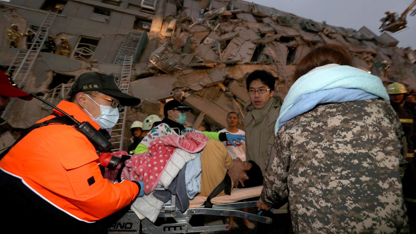 In Tainan, rescue workers transport a person injured in the earthquake that struck at 3:57 a.m. local time Saturday.
