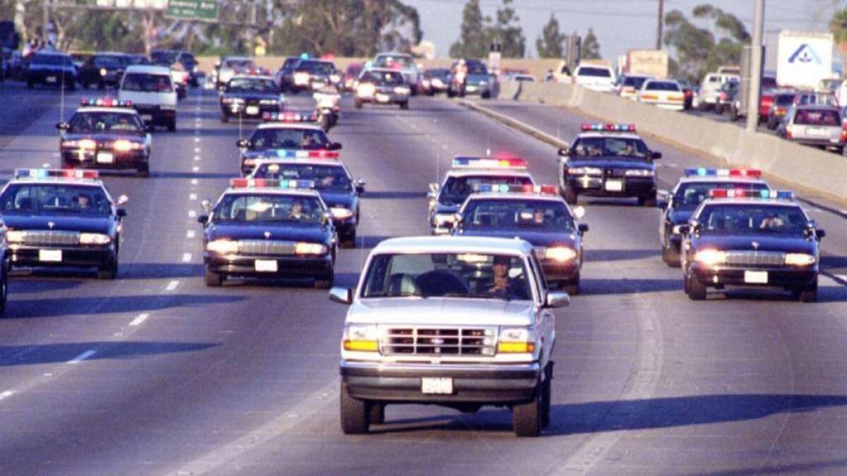 California Highway Patrol officers chase Al Cowling, driving, and O.J. Simpson, in the rear of the white Bronco, on the 91 Freeway just west of the 5 Freeway on June 17, 1994.