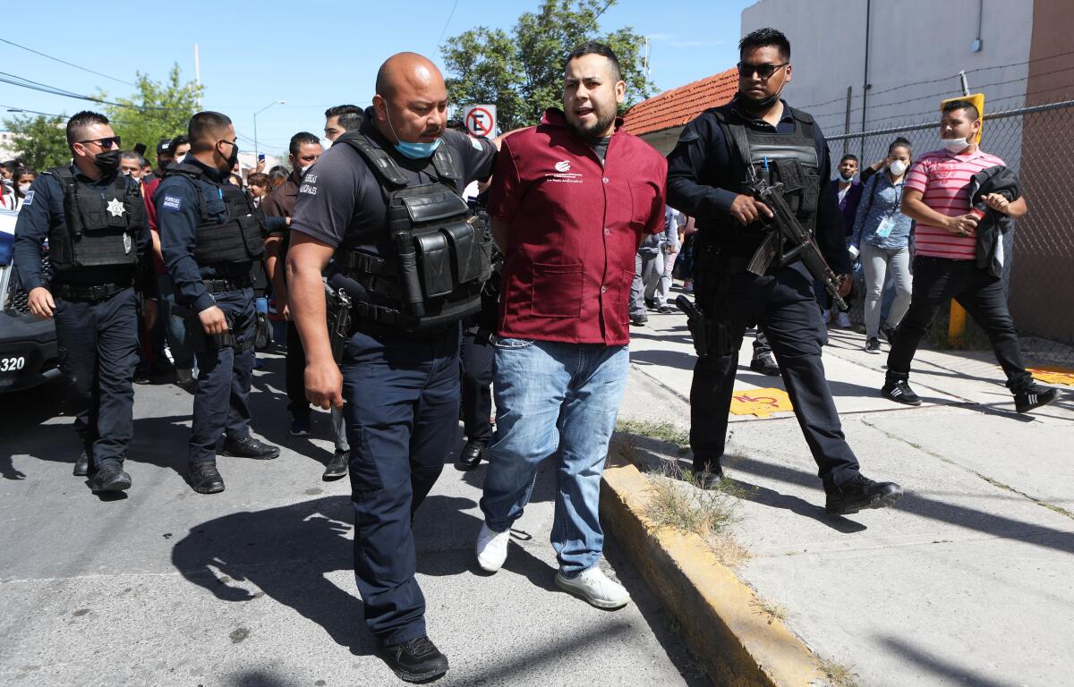 A worker at a foreign-owned factory in Juarez, Mexico, is detained after protesting safety conditions.