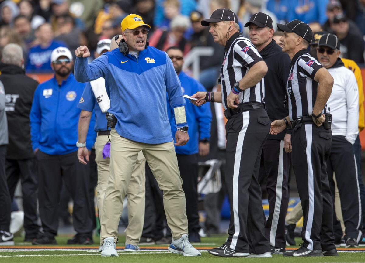 Pittsburgh coach Pat Narduzzi, left, argues win a referee during a win over UCLA in the Sun Bowl on Dec. 30.
