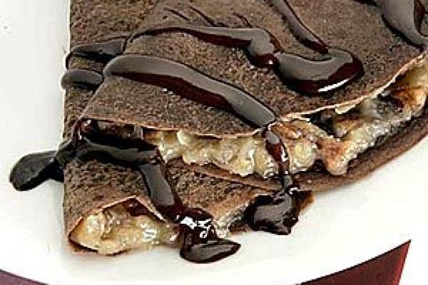 The crepes themselves are made with melted chocolate, enfold the custard filling, then topped with just a drizzle of melted chocolate and cream.
